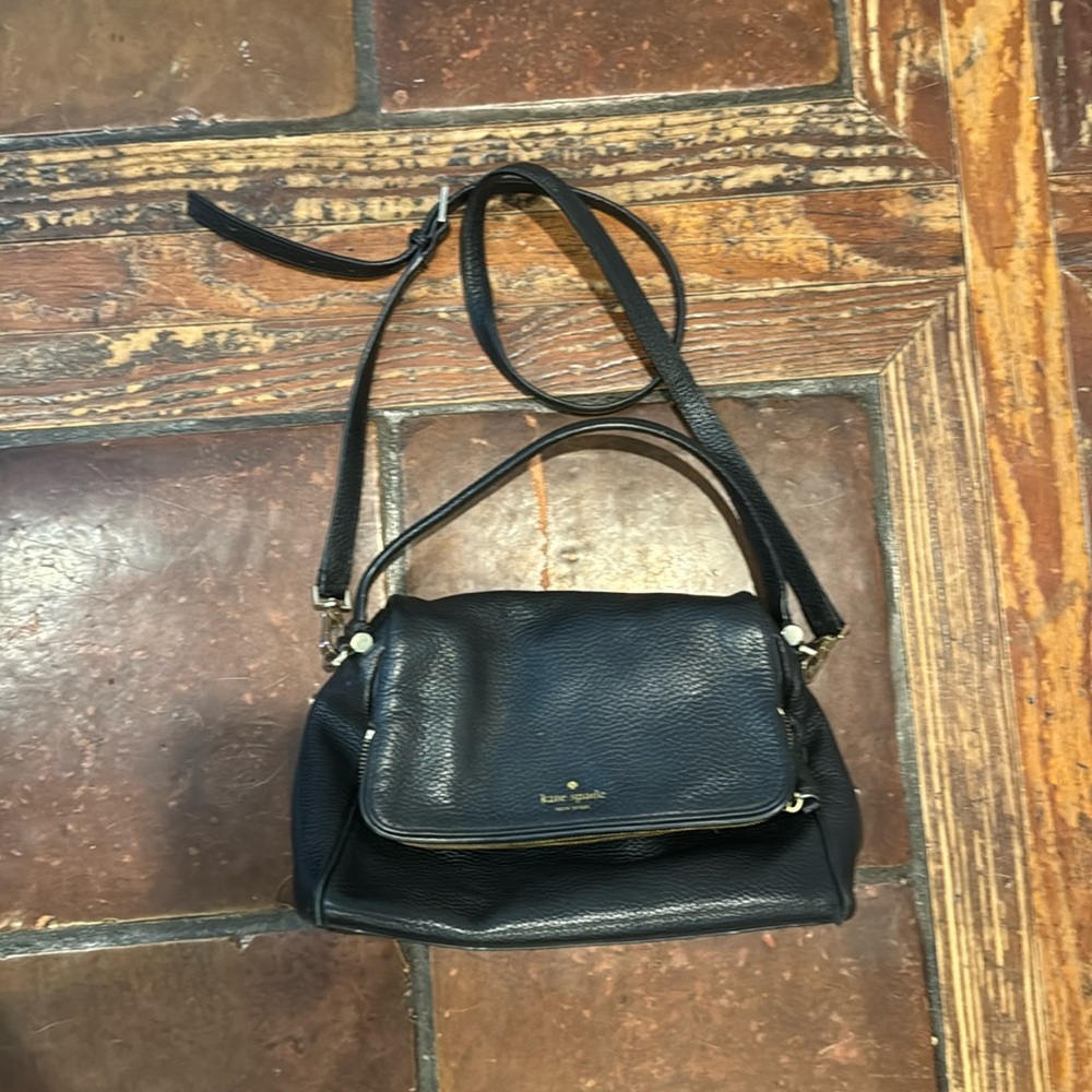 Black Kate Spade purse with long strap.